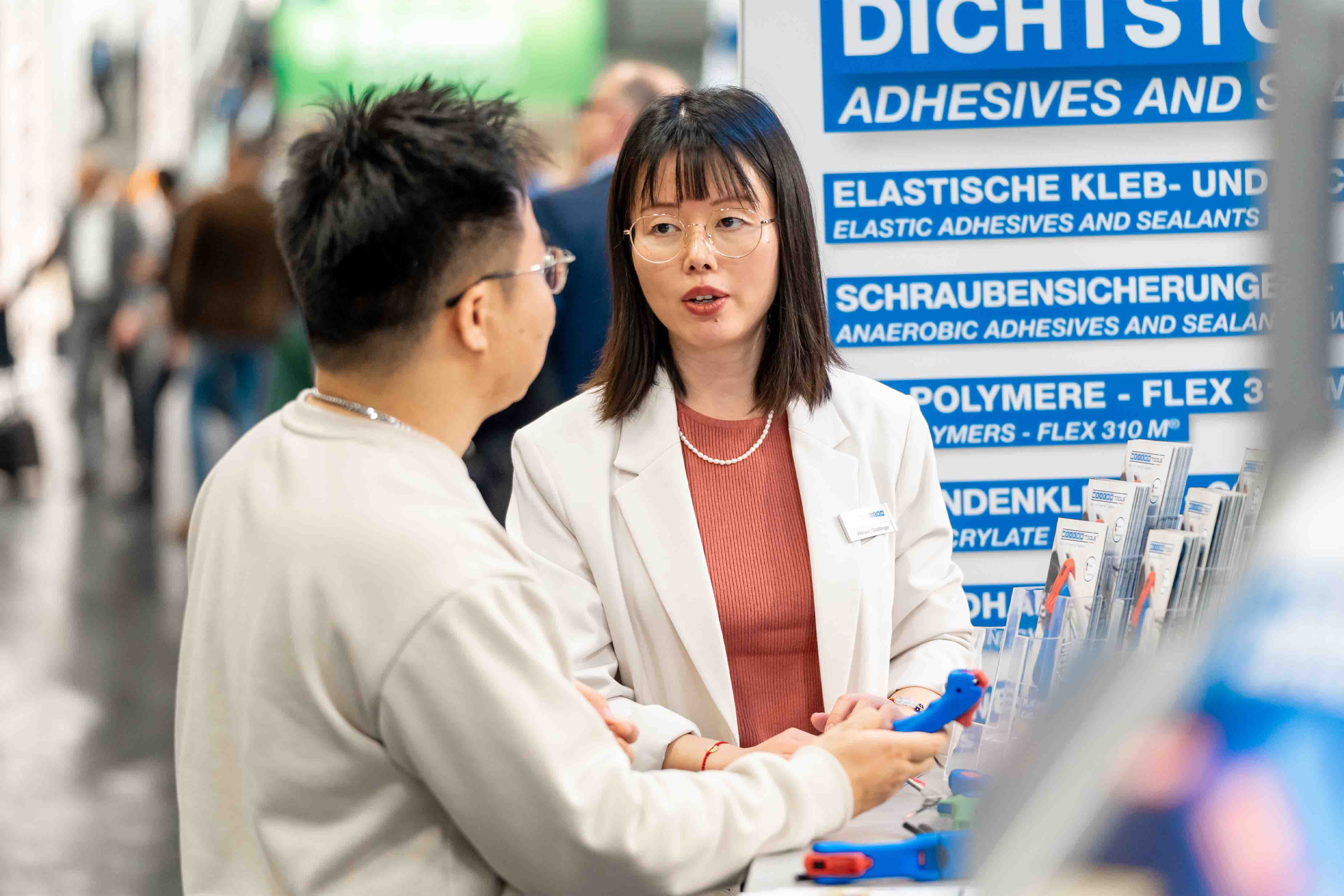 office, lanyard, name badge, glasses, two people